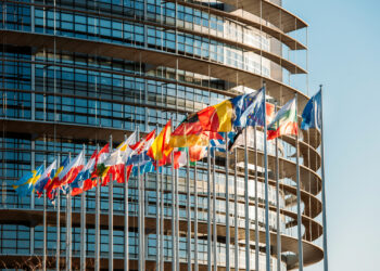 Strasbourg, France - January 28, 2014: The European Parliament building in Strasbourg, France with flags waving on a spring evening