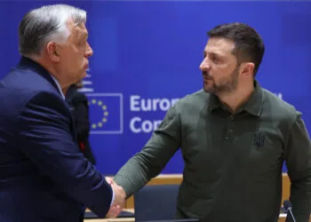 Hungarian Prime Minister Viktor Orban (L) shakes hands with Ukraine's President Zelensky during the European Council Summit at the EU headquarters in Brussels on June 27, 2024. (Photo by Olivier HOSLET / POOL / AFP)