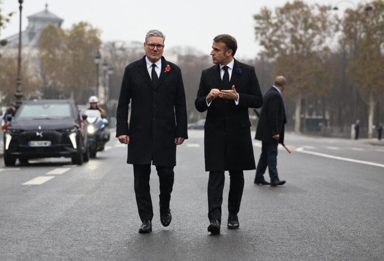 French President Emmanuel Macron (R) and British Prime Minister Keir Starmer (L) walk towards the statue of Winston Churchill in Paris, on November 11, 2024, as part of the commemorations marking the 106th anniversary of the November 11, 1918, Armistice, ending World War I (WWI). (Photo by Christophe PETIT TESSON / POOL / AFP)