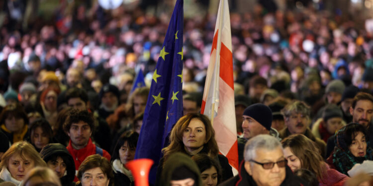 Anti-government protesters stage a march in support of detained fellow activists during a tenth consecutive day of mass demonstrations against the government's postponement of European Union accession talks until 2028, in central Tbilisi on December 7, 2024. (Photo by Giorgi ARJEVANIDZE / AFP)