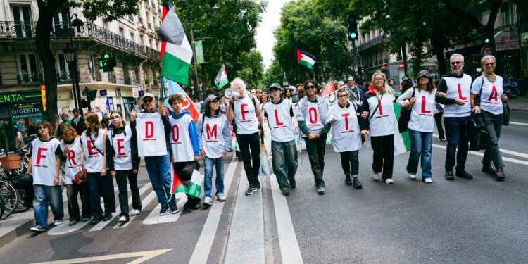 Demonstrators march in a line with T-shirts each bearing a letter to form the slogan Freedom Flotilla (flotilla for the liberation of Gaza with activist G Thunberg and MEP R Hassan of La France Insoumise LFI on board), Demonstration Stop Genocide, no to the dissolution of Urgence Palestine in support of the Palestinian population and Gaza, war between Hamas and the Israeli army following the terrorist attacks of 7 October 2023, starting from Place de la Republique in Paris, France on June 7, 2025. Israeli-Palestinian conflict. (Photo by Amaury Cornu / Hans Lucas via AFP)