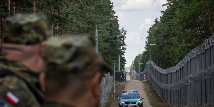 A border guard vehicle drives along the border fence at the Polish-Belarusian border in Polowce-Pieszczatka, Poland on July 21, 2025, during a visit of the Polish Interior Minister and his German counterpart.  (Photo by Wojtek RADWANSKI / AFP)