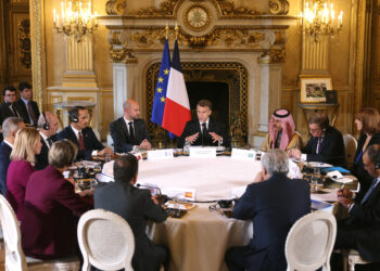 France's President Emmanuel Macron (C), next to France's outgoing Minister for Europe and Foreign Affairs Jean-Noel Barrot (L), speaks during a Ministerial meeting on the implementation of the Middle East peace plan at the Quai d'Orsay, France's Ministry for Europe and Foreign Affairs, in Paris, on October 9, 2025. (Photo by Thomas SAMSON / POOL / AFP)
