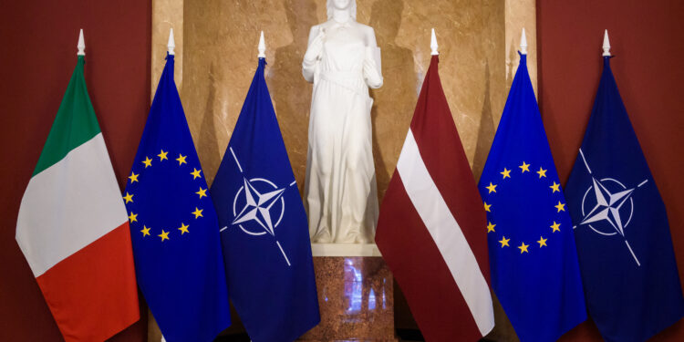 Italian, EU, NATO and Latvian flags are lined up ahead of the mmeeting of the Italian and Latvian Prime Ministers in Riga on July 10, 2023. (Photo by Gints Ivuskans / AFP)