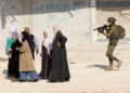 An Israeli soldier tries to prevent Palestinians from reaching their houses in Nur Shams refugee camp in the West Bank city of Tulkarm, Nov. 18, 2025. Palestinians took part in a demonstration demanding the right to return to their houses at the entrance of Nur Shams refugee camp, while Israeli soldiers assaulted the crowd and forced them to leave the area. [Photo by Nidal Eshtayeh/Xinhua/ABACAPRESS.COM, via IPA agency]