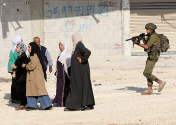An Israeli soldier tries to prevent Palestinians from reaching their houses in Nur Shams refugee camp in the West Bank city of Tulkarm, Nov. 18, 2025. Palestinians took part in a demonstration demanding the right to return to their houses at the entrance of Nur Shams refugee camp, while Israeli soldiers assaulted the crowd and forced them to leave the area. [Photo by Nidal Eshtayeh/Xinhua/ABACAPRESS.COM, via IPA agency]