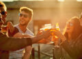 Together is our favorite place to be. a group of young diverse friends having a drink and spending the day outside on a rooftop.